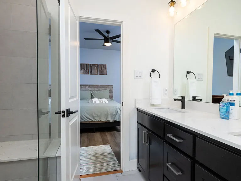 Primary full bathroom - walk-in shower and double sinks.