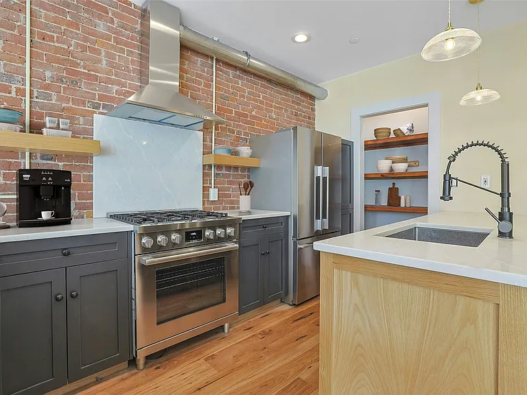 Kitchen: Virtually staged chef's kitchen with luxury stainless steel appliances and custom pantry.