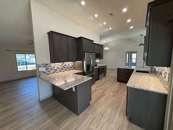 Kitchen from kitchen sliding door showing breakfast nook with room for stools