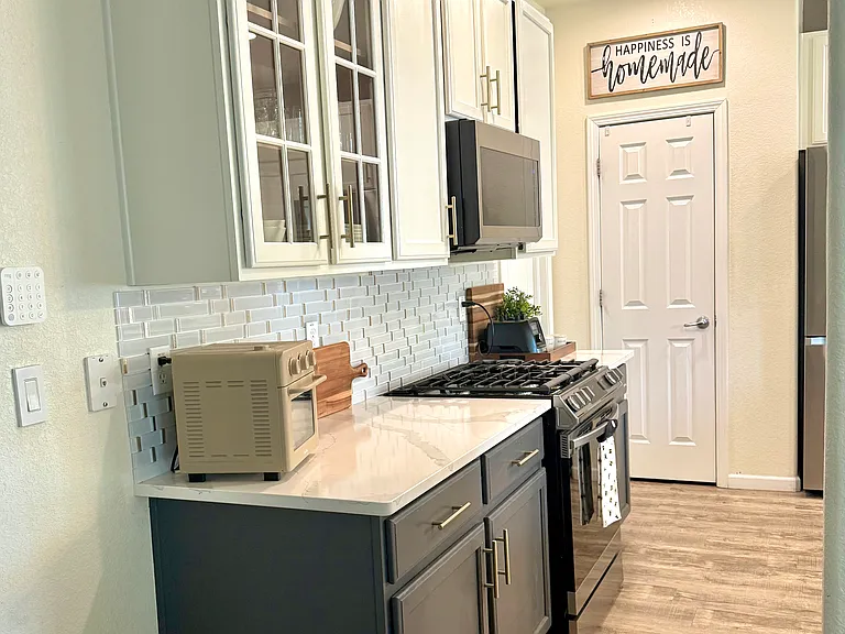 Kitchen view from hallway and door to pantry