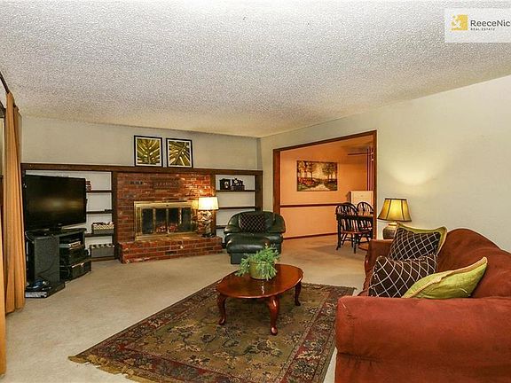 The inviting great room has a used brick fireplace with gas logs and built-in bookcases.