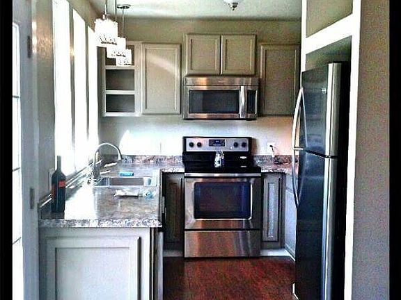 Chic styled galley kitchen is decked out with all new stainl