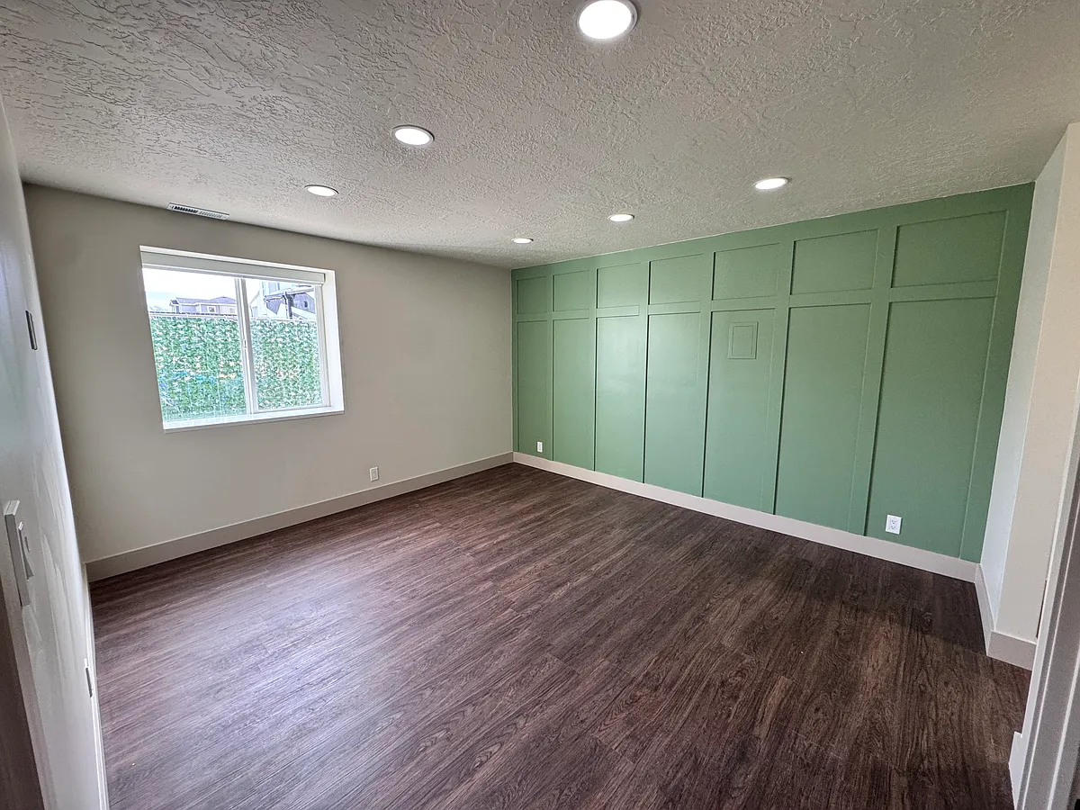 Spacious master bedroom with abundant natural light, modern finishes, and a comfortable, open layout. - 1328 W 825 S #B