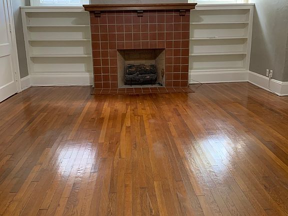 Beautiful, spacious living area with coffered ceiling and built in bookshelves