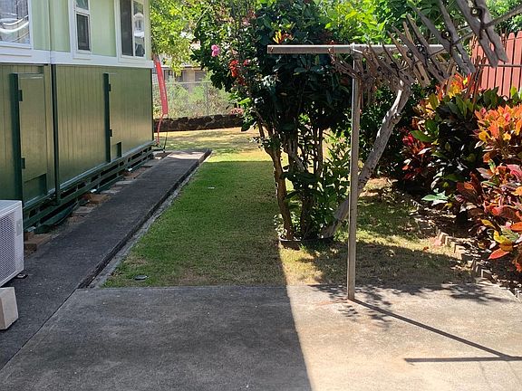 The side of the home has a covered outside clothesline to hang dry laundry