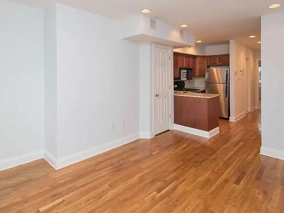 Living room with view into kitchen