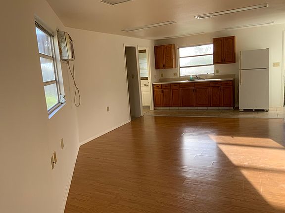living area w/ small walk-in closet and storage on the sides.