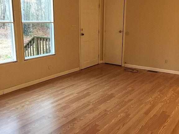 living room with laminate floors...lots of windows and coat closet