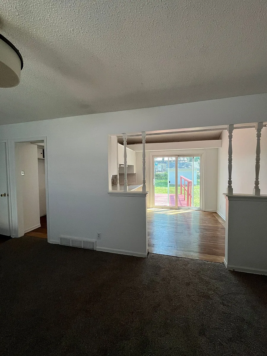 View of kitchen and deck from living room - 125 E 132nd Ter