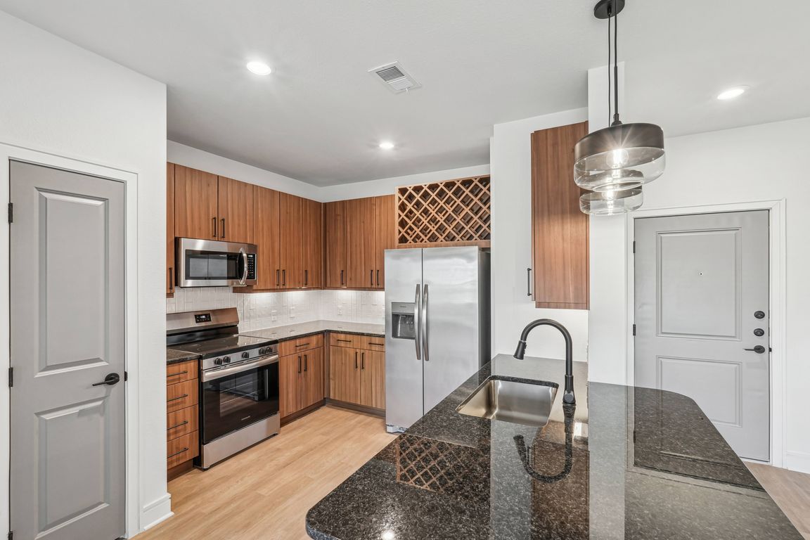 Kitchen with Granite Countertop and Stainless Steel Appliances.