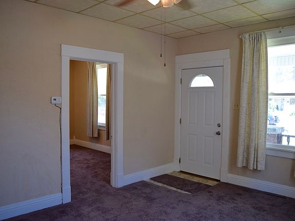 Front living space, front door, and door to front bedroom