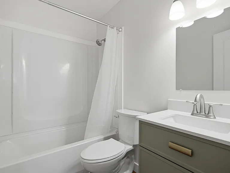 Full hallway bath includes fresh paint, a new toilet, and a stylish new vanity.