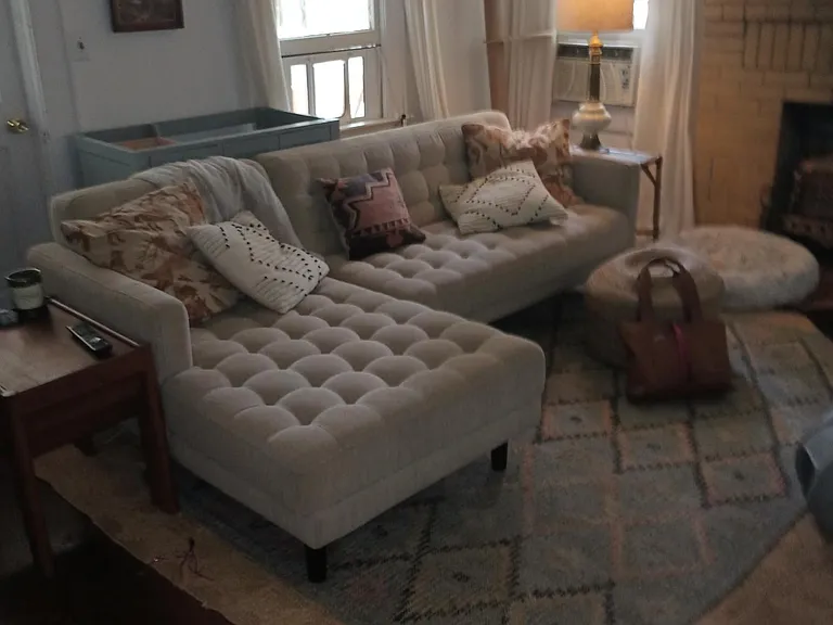 Living Room w/ partial view of yellow brick decorative fireplace.