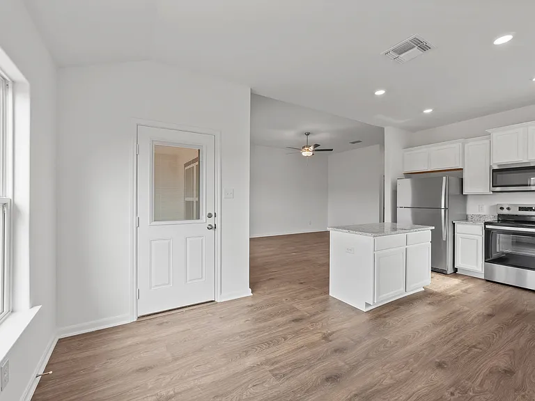The door in the dining room leads to the backyard.