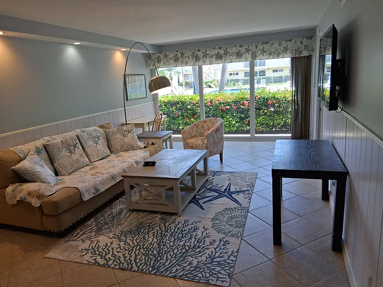 casual living room with pool view - sofa and full tv channels & wifi.