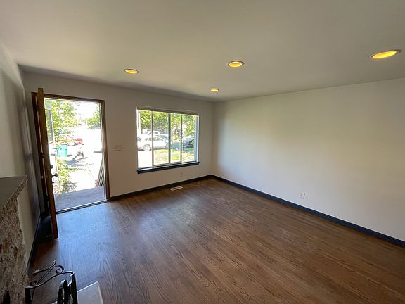 Spacious living area with fireplace and west-facing light.