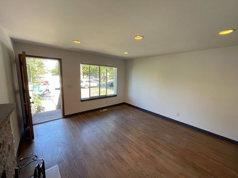 Spacious living area with fireplace and west-facing light.
