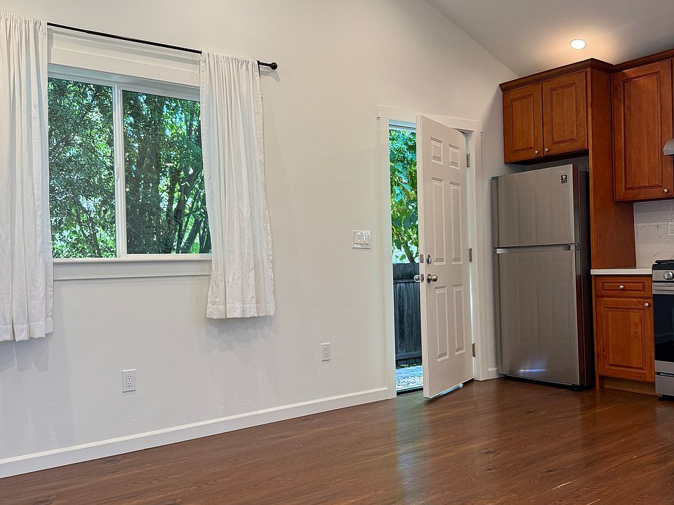 Living room facing front door and kitchen