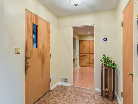 This inviting front entry greets you with original vintage tile work and a walk in front coat closet.