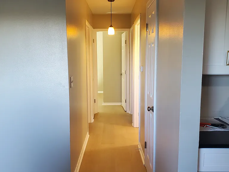 Hallway.
Kitchen is to the right. 
Three bedrooms and full bathroom