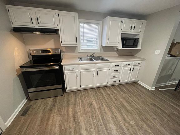 Freshly painted cabinets with new handles, updated Electric Range and microwave