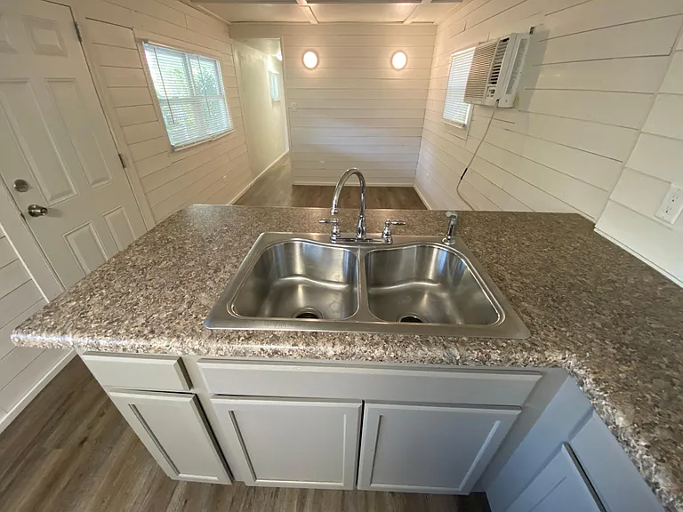Open concept kitchen into living room, heat air combo in living room