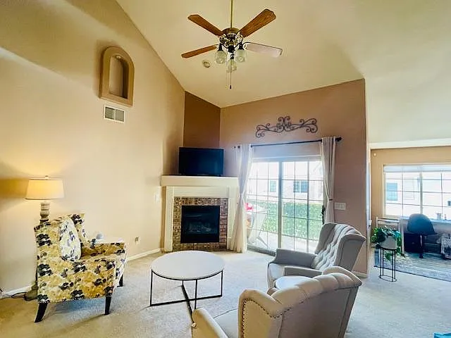 Living Space with tall 25 ft ceiling and gas fireplace