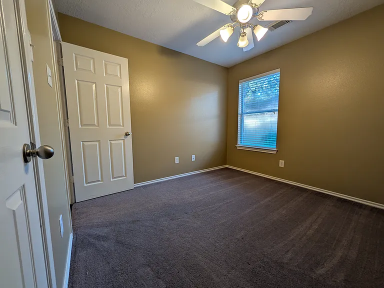 Highlighting the entry and closet doors of Bedroom 4, this view emphasizes the home's consistent finish and plentiful storage options.