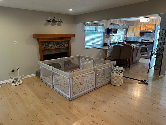 Spacious Living Area: Enjoy a bright and airy living room with large windows and a cozy fireplace. Ideal for relaxing or entertaining guests (pardon the kid stuff)