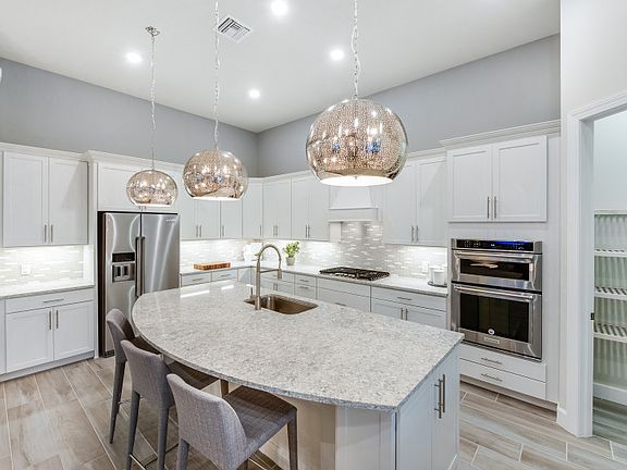 Thoughtfully designed Kitchen featuring built-in gas appliances and quartz countertops