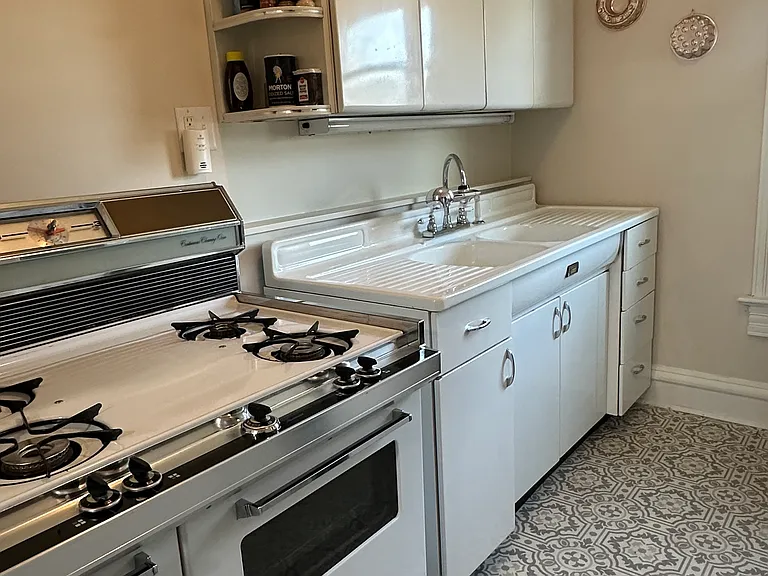 Retro kitchen with new refrigerator. Also has a washer and dryer.