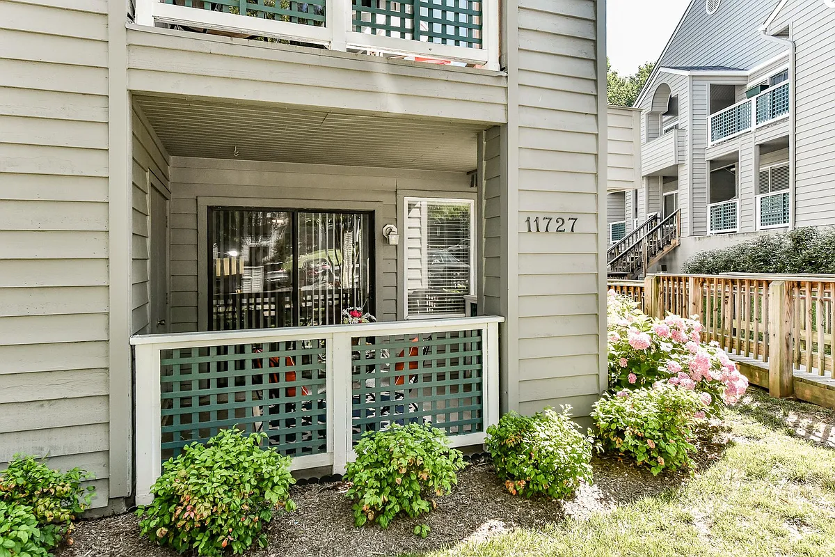 Beautiful lush landscaping surrounds enclosed patio. - 11727 Summerchase Cir #A