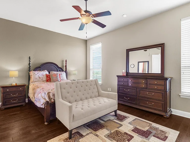 Large primary bedroom on the first floor faces the greenbelt. More gleaming hardwoods!