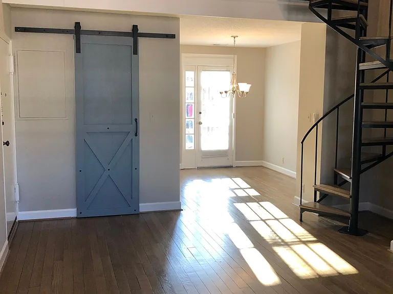 Living rm. and Dining Area. Barn door access to front hall coat closet. Loft space above.