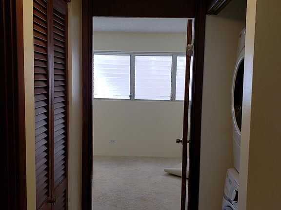 Hallway closet and washer/dryer leading to 2nd bedroom