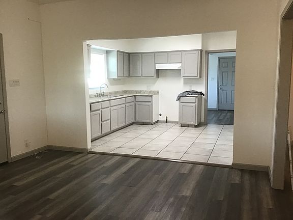 View from the den into the kitchen. Entire interior completely renovated from floor to ceiling.
