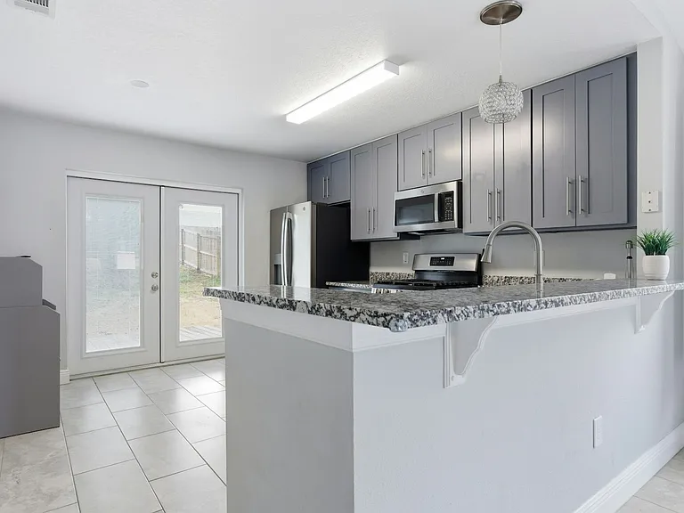 Kitchen with all stainless steel appliances, gas range, soft close cabinets & granite counter tops