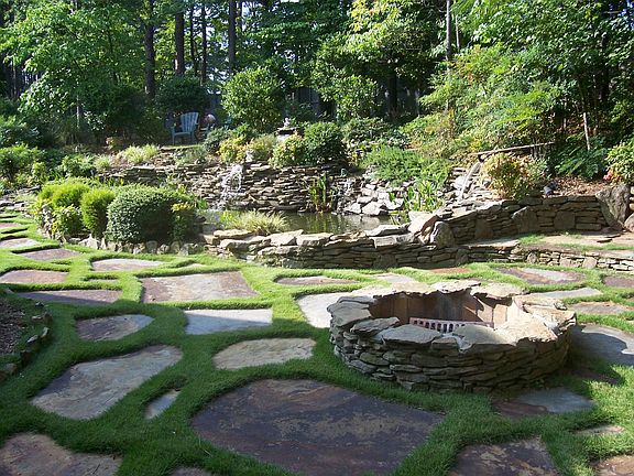 Large custom built rock pond with 5 waterfalls. Slate pavers and firepit.