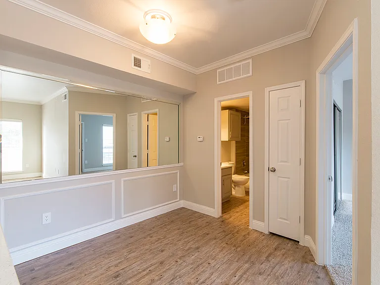 Dining with vaulted ceiling and natural light leading to 1/2 bath