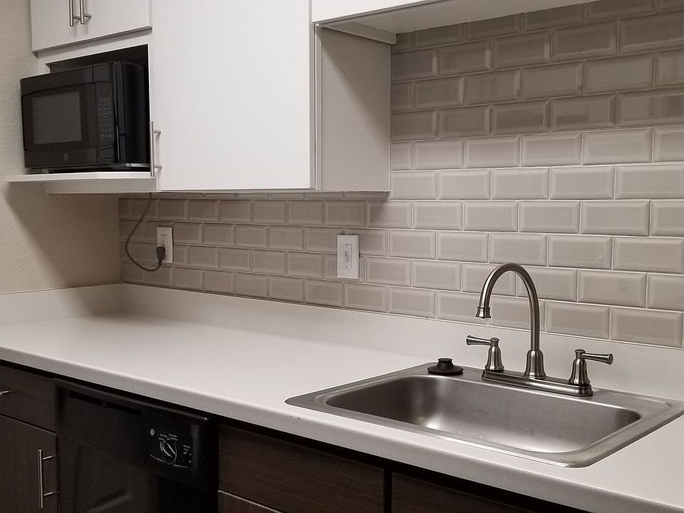 Avery Belmar - Upgraded kitchen with a glass tile back splash.