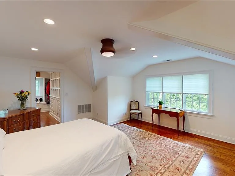 Sunny primary suite with custom walk-in closet
