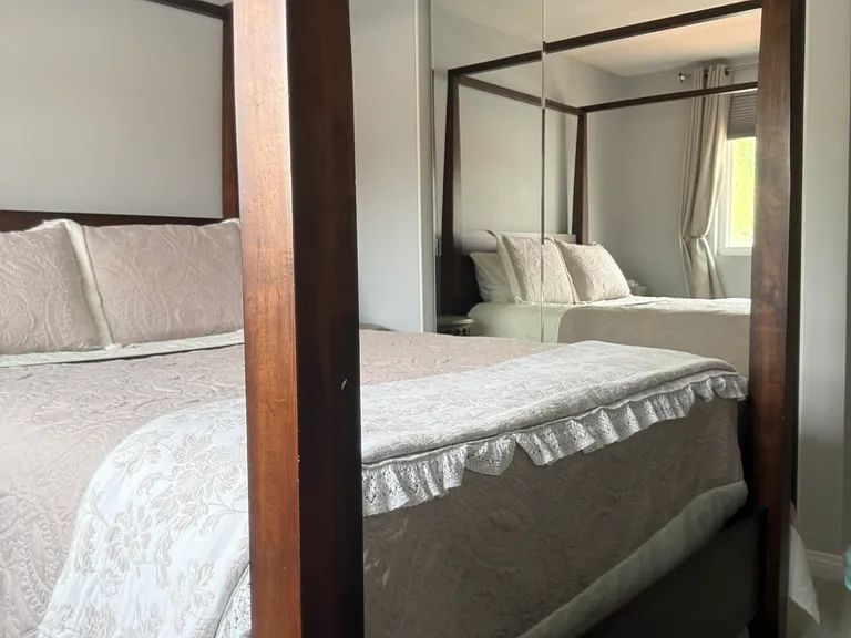 Guest room with floor to ceiling mirrored closet