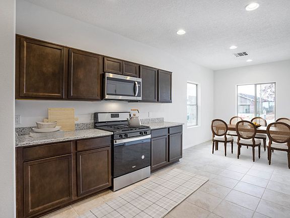 The kitchen boasts ample storage space throughout and a separate cafe.