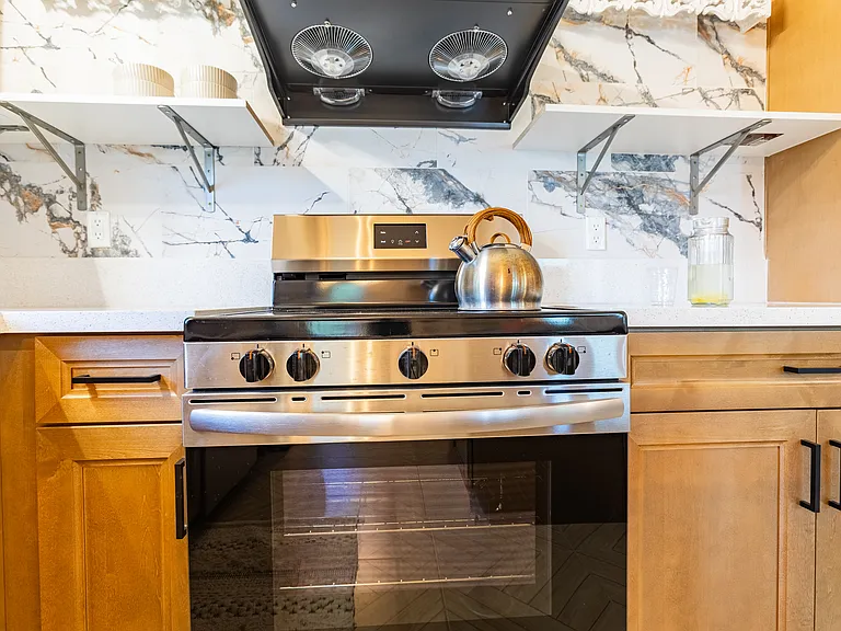 Electrical Frigidaire stove with 5 burners with PacAir ventilation stove hood.