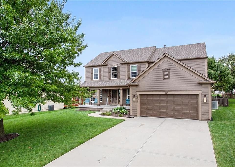Front Elevation with ex long driveway and beautiful landscaping