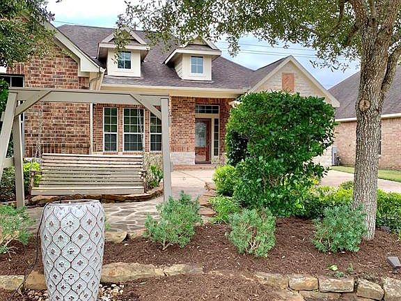 Nicely landscaped with water feature and swing.