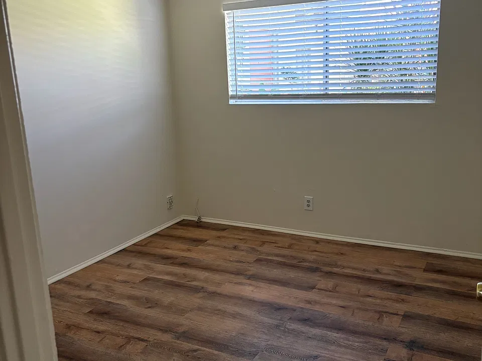 Large bedroom with new laminate flooring and large closet.