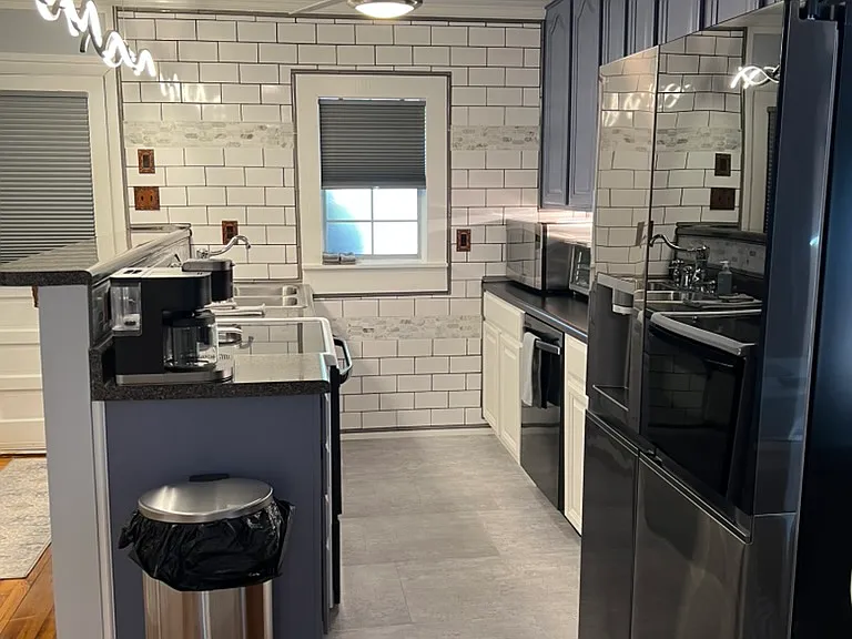 Plenty of cabinet space. Overhead light/fan. Full size new fridge. Modern lighting.