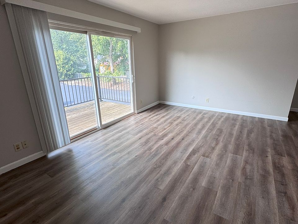 LIVING ROOM WITH SLIDING GLASS DOOR TO BALCONY - TAKEN FROM ENTRANCE DOOR