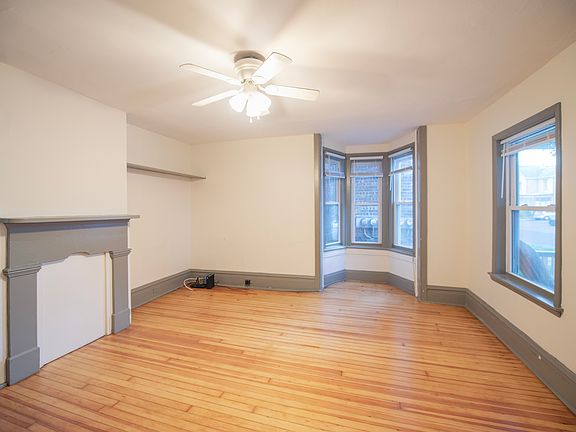 bright, spacious living room with refinished hardwood floors